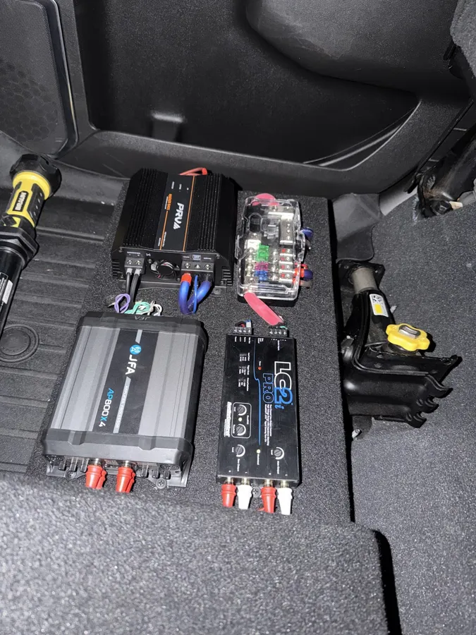 Amplifiers mounted under the rear seat on a car audio install in DeBary, FL